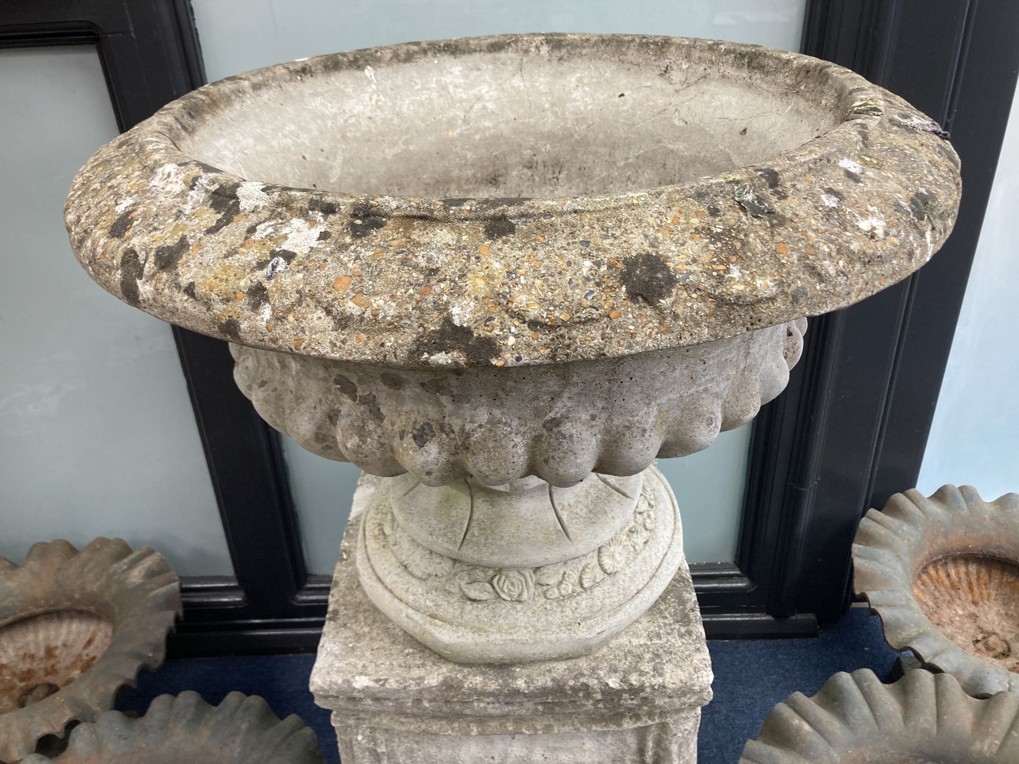 A reconstituted stone campana shaped garden urn, on square plinth, diameter 64cm, height 97cm